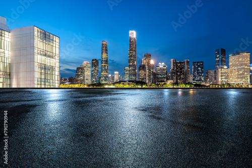 Asphalt road with modern city buildings scenery at night. Road ground after rain. © ABCDstock
