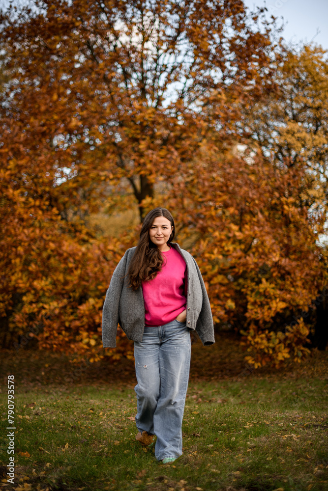 Cute smiling woman with long hair walking towards the camera on green grass Cute smiling woman with long hair walking towards the camera on green grass