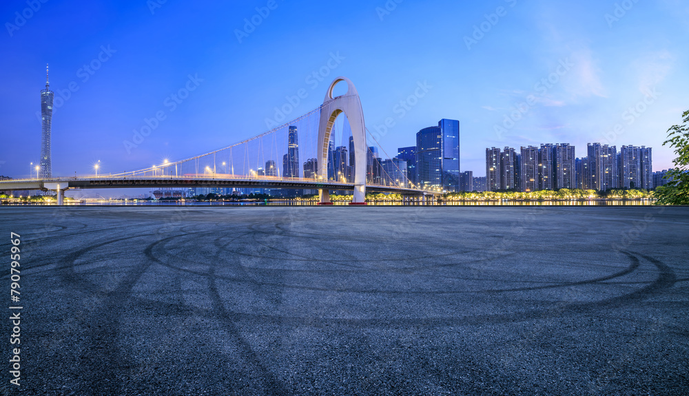 Asphalt road square and bridge with modern city buildings scenery at night in Guangzhou