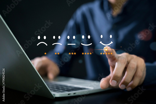 Customer services best excellent business rating experience , Business people are touching the virtual screen on the happy Smiley face icon to give satisfaction in service. rating very impressed. © A Stockphoto