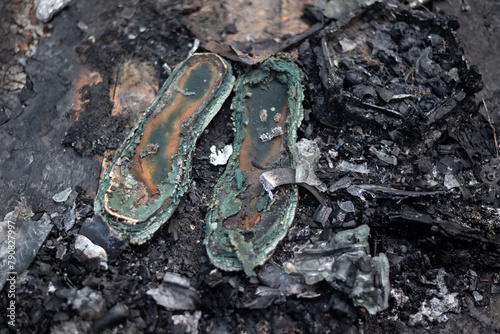 old burnt shoes in ashes photo