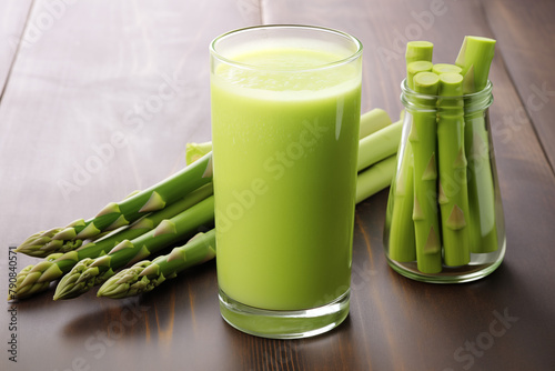 A glass of Asparagus juice and slices of Asparagus isolated on white background cutout