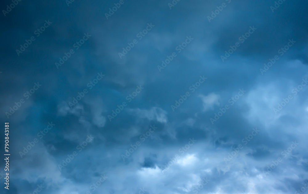 Storm clouds, moody weather in the dark blue sky background. Storm season.