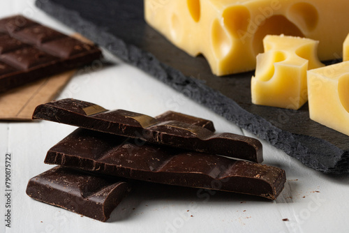 Dark chocolate with cheese on the table. A tasty and healthy snack.