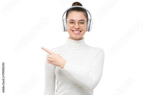 Young woman wearing glasses and wireless headphones, pointing to the left with finger as if recommending new music photo