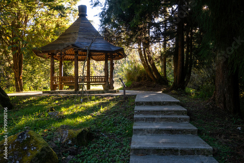 Sunlight filtering through a pavilion at sunset in Alishan National Forest Recreation Area, Taiwan.