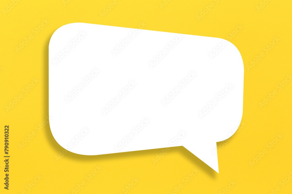 Empty white paper in speech bubble shape set against yellow background. Empty white paper in speech bubble shape set against yellow background.