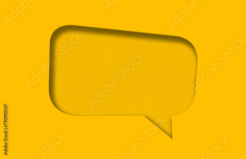 Yellow paper cut into holes speech bubble shape.