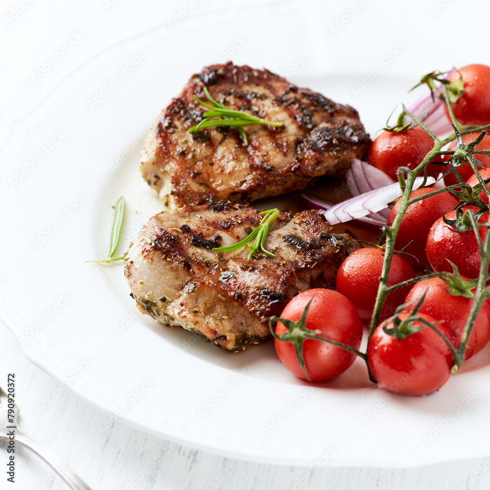 Grilled Chicken Breast with roasted Cherry Tomatoes. Bright wooden background Grilled Chicken Breast with roasted Cherry Tomatoes. Bright wooden background