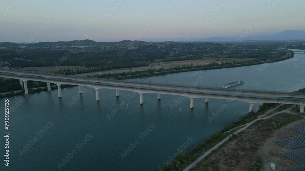 Panoramic bird's eye view of a passenger ship passing under the double viaduct on the Rhone River in Avignon - France. Panoramic bird's eye view of a passenger ship passing under the double viaduct on the Rhone River in Avignon - France.