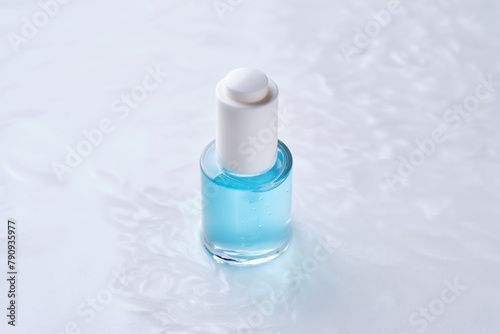Bottles of serum with a dropper in liquid with pearl tints.