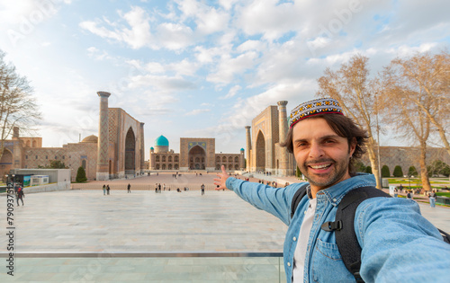 happy tourist take photo selfie with Registan in Samarkand, travel in Uzbekistan, Central Asia