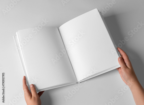 open Empty Book Template on White Background, hands Open book with blank pages. Mock up for design