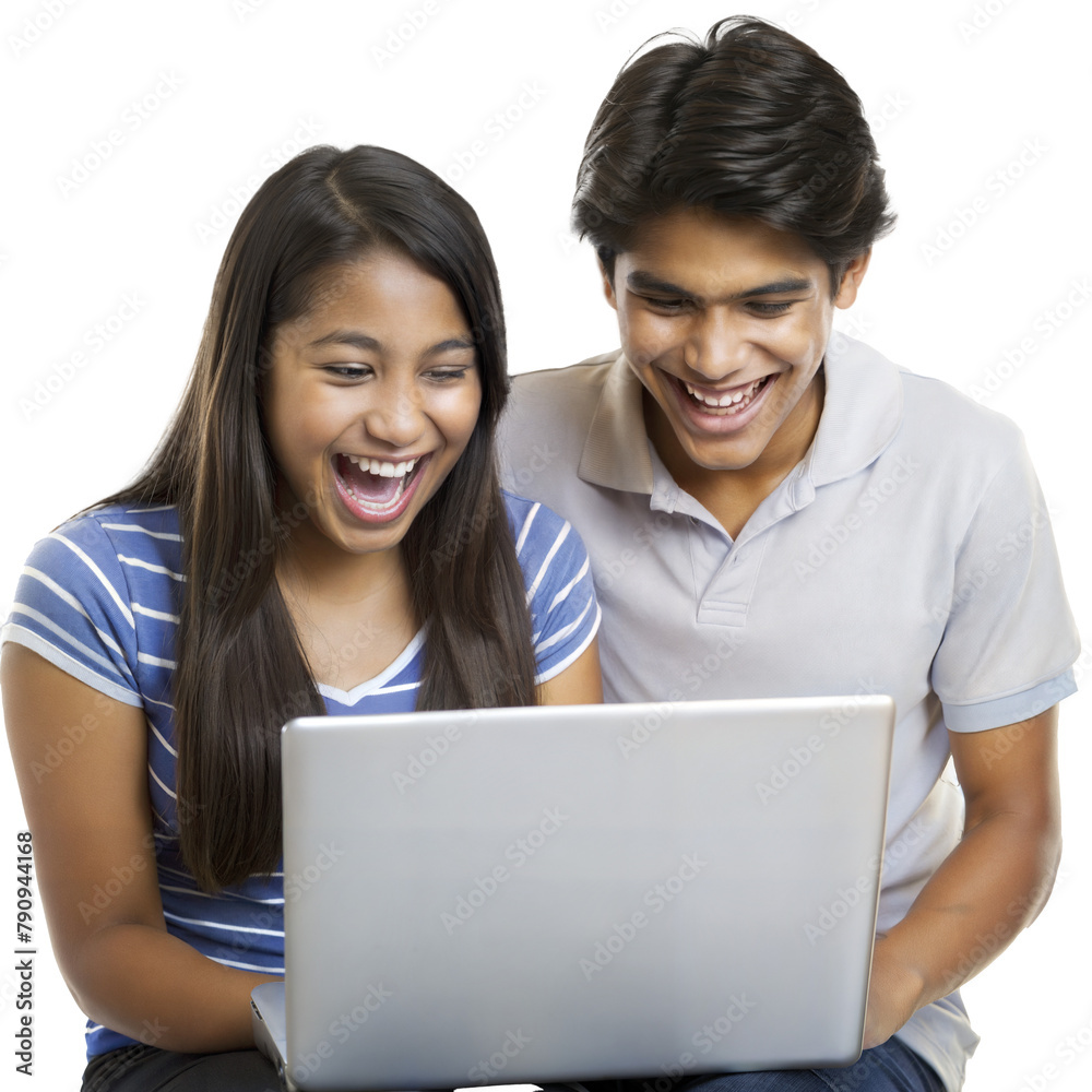 Teenage friends laughing while using a laptop together Teenage friends laughing while using a laptop together