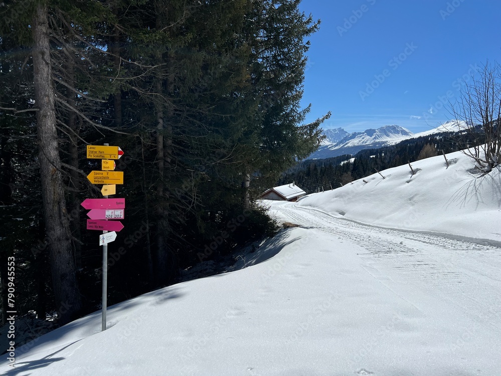 Hiking markings and orientation signs with signposts for navigating in the idyllic winter ambience above the tourist resorts of Valbella and Lenzerheide in Swiss Alps - Canton of Grisons, Switzerland Hiking markings and orientation signs with signposts for navigating in the idyllic winter ambience above the tourist resorts of Valbella and Lenzerheide in Swiss Alps - Canton of Grisons, Switzerland