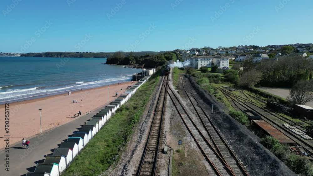 Goodrington Sands, South Devon, England: DRONE VIEWS: A steam train on route to Paignton on the Torbay Steam Railway line. The steam trains are a major tourist attraction for UK holidaymakers (Clip 2) Goodrington Sands, South Devon, England: DRONE VIEWS: A steam train on route to Paignton on the Torbay Steam Railway line. The steam trains are a major tourist attraction for UK holidaymakers (Clip 2)