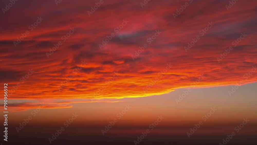 Clouds at Sanset. The sun has gone behind the horizon and lights a large cloud. Time-laps 40X Clouds at Sanset. The sun has gone behind the horizon and lights a large cloud. Time-laps 40X