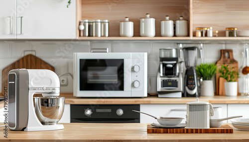 Microwave oven, coffee machine, mixer and set of plates on wooden table in modern kitchen photo