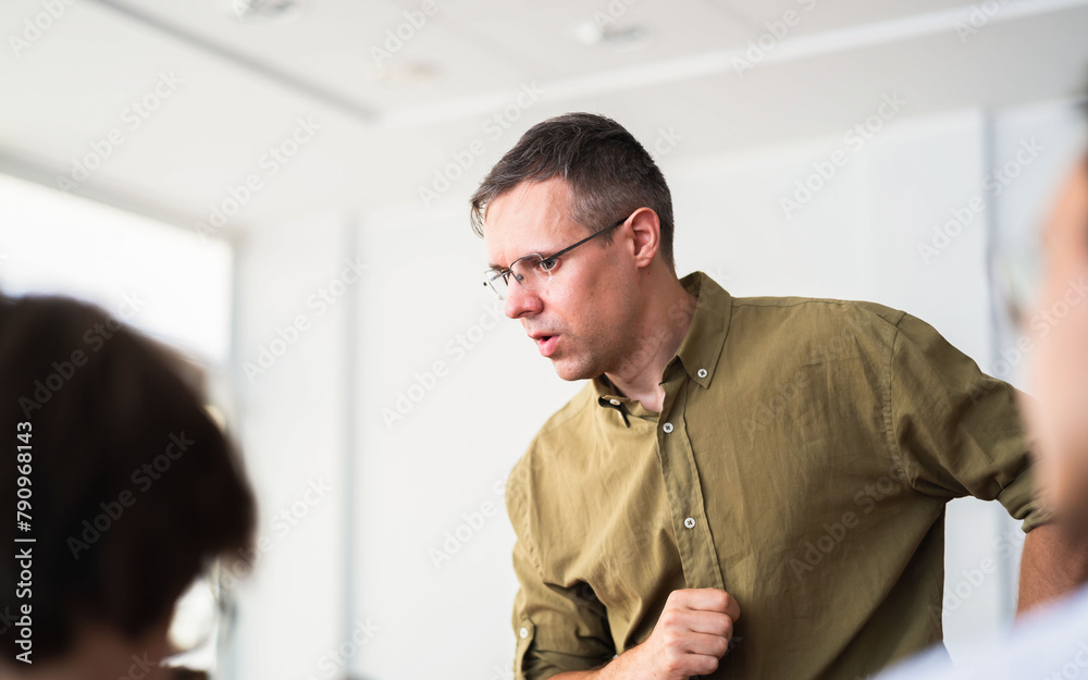 Fototapeta premium white caucasian Lecturer with glasses in class, military shirt