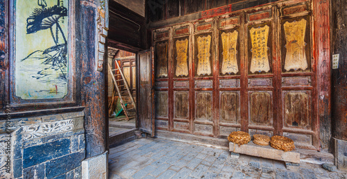 Richly decorated facade at the courtyard of a historic house in the ancient town of Tuan Shan, Yunnan province China