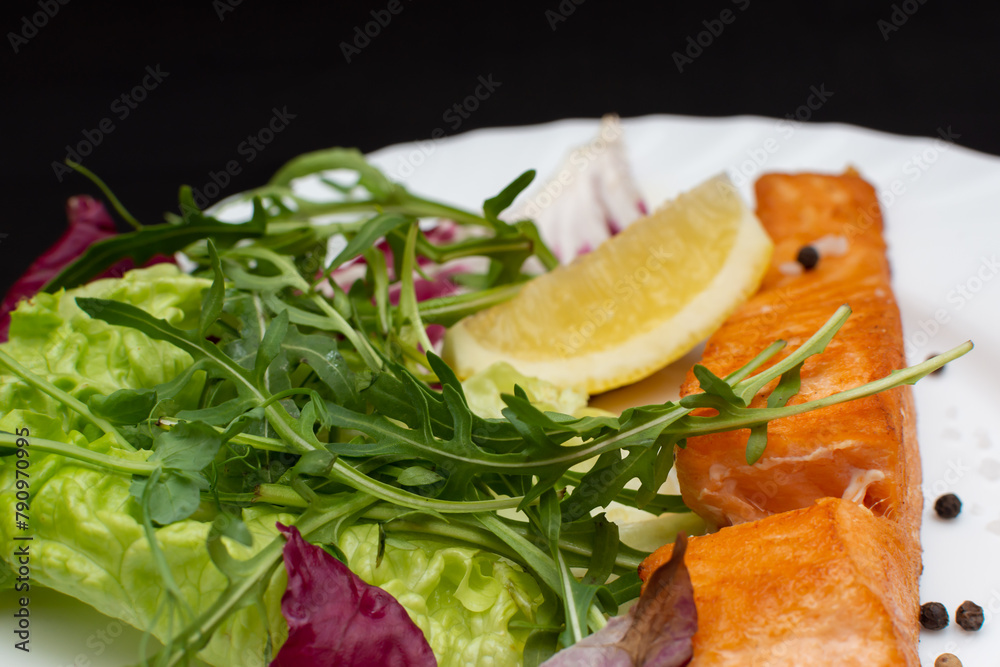 Salmon and lemon on white plate, garnished with herbs and egg yolk Salmon and lemon on white plate, garnished with herbs and egg yolk