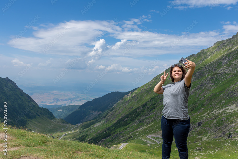 a woman taking a picture of herself in the mountains