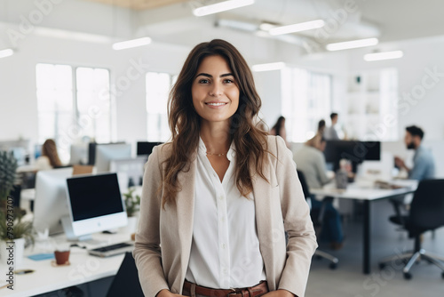 Candid portrait of 30 year old woman, ceo of successful startup company, in the office at work