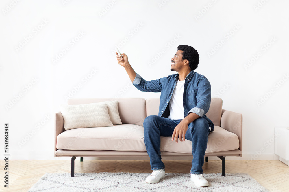 Engaged Black Guy Pointing at Something in his Home Engaged Black Guy Pointing at Something in his Home