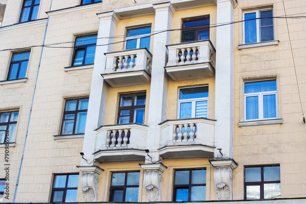 A property with azure windows and balconies, a fixture in the buildings facade A property with azure windows and balconies, a fixture in the buildings facade