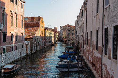 Panoramic view of a water channel in city of Venice, Veneto, Italy, Europe. Venetian architectural landmarks and old houses facades along the man made water traffic corridor. Urban tourism in summer © Chris