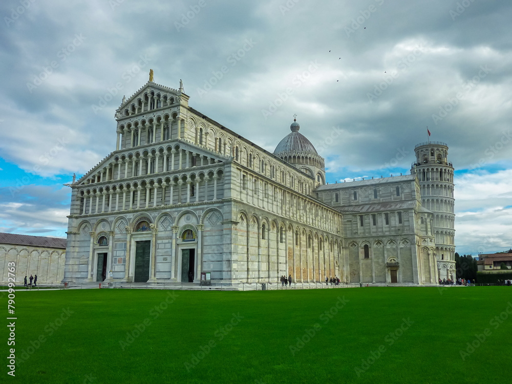 Scenic view of Leaning tower of Pisa and the Baptistry and Duomo seen from Piazza dei Miracoli, Pisa, Tuscany, Italy, Europe. Nearly four degree lean. Partially cloudy day in summer. Sightseeing