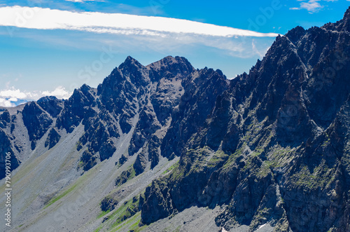 Panoramic view from mountain summit Monte Viso (Monviso) in the Cottian Alps, Cuneo, Piemonte, Italy, Europe. Massive rock walls and ridges of the Stone king. Majestic landscape. Wanderlust, climbing photo