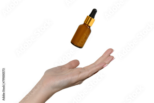 Cosmetic oil for skin care. Hand of a young girl.