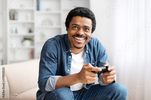Man with a game controller grinning widely photo