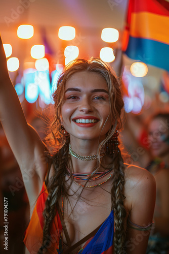 Smiling woman with braids holding flag