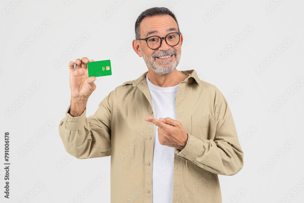 Senior man pointing at a credit card Senior man pointing at a credit card