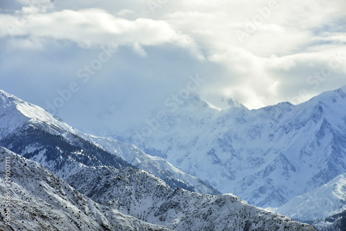 Breathtaking view of snow-covered mountains under a cloudy sky