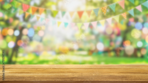 Empty wooden table with party in backyard, blurred background with festive bunting