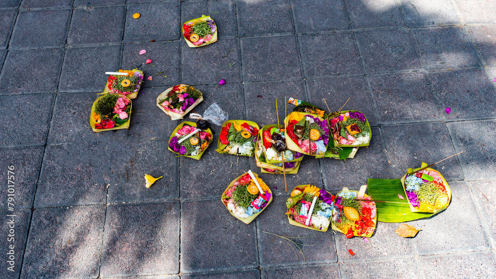 Bali MARCH 2024 - Traditional balinese handmade canang sari offering to gods on a street. Bali island. Indonesia.