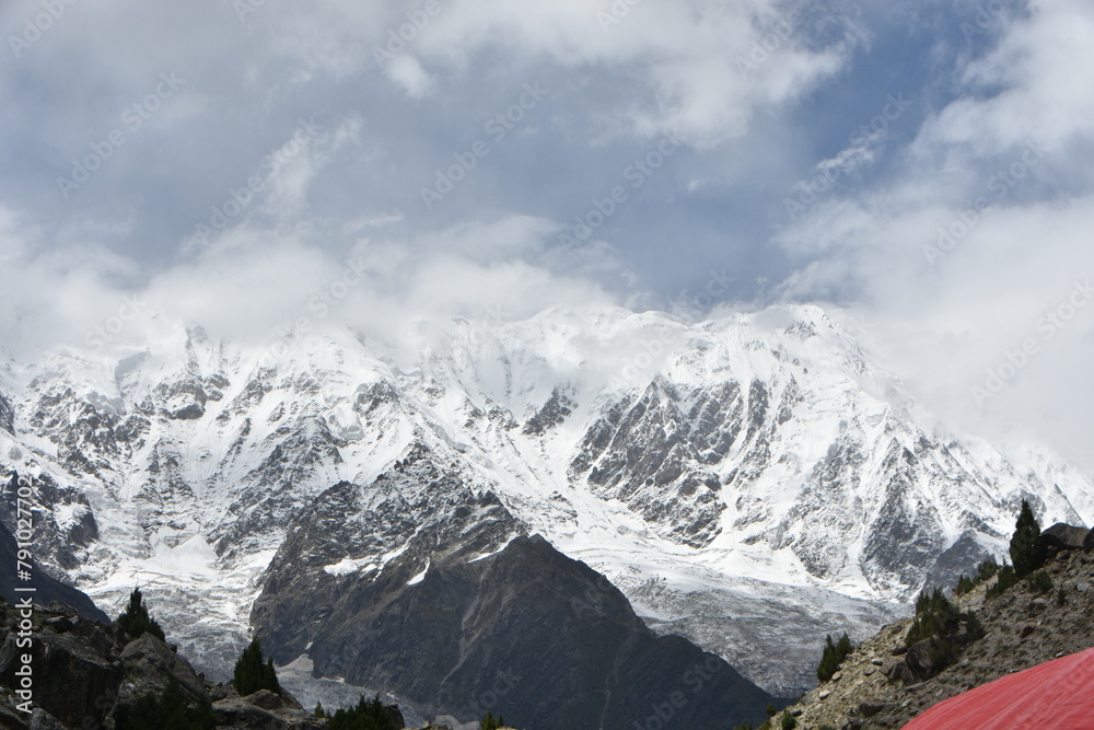 Majestic mountain peaks with snow under cloudy skies