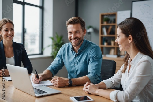 Smiling Male and female entrepreneurs attending meeting at office