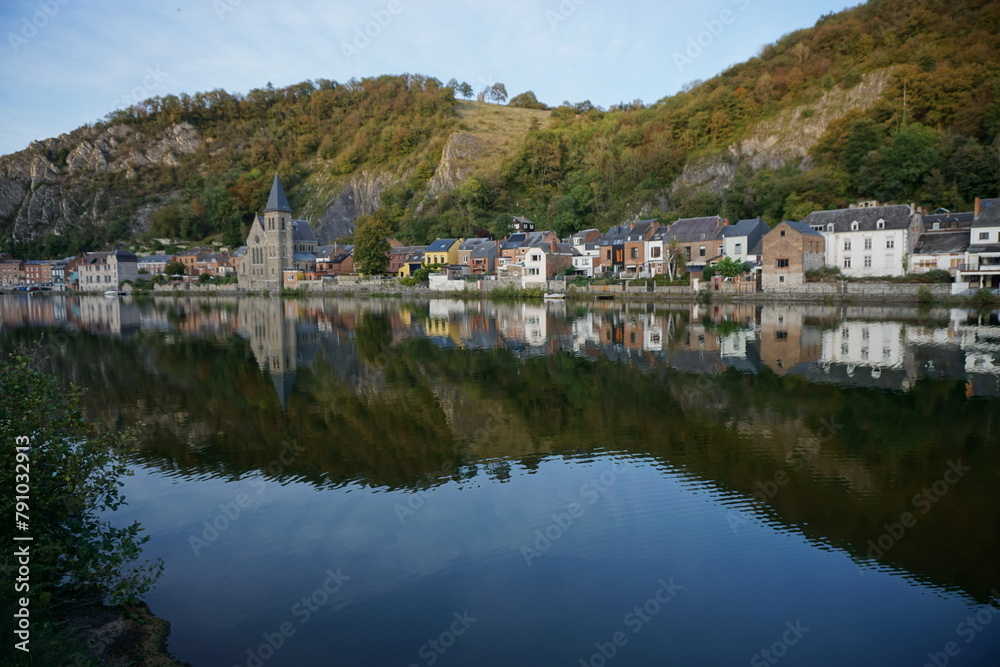 view of the town of Dinant in Belgium on the Meuse river with mirror reflection 