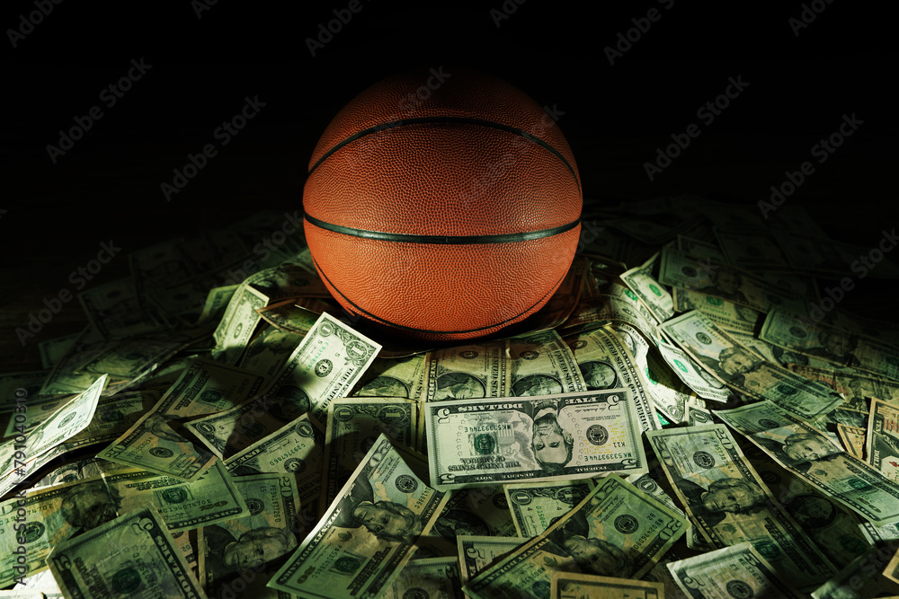 Fototapeta premium Basketball on a pile of cash -- money and betting in sports concept