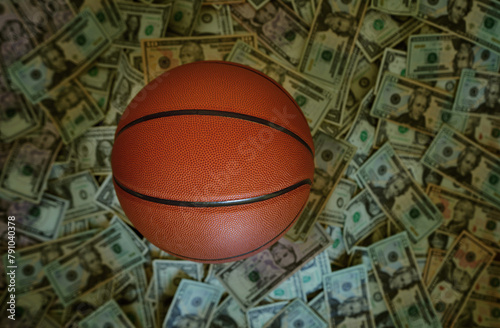 Basketball on a pile of cash -- sports betting concept