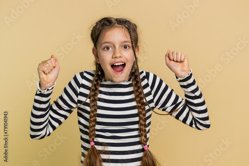 Young preteen child girl kid feeling hopelessness and loneliness, nervous breakdown, loses becoming surprised by game fail, bad fortune, loss, unlucky news. Teenager children on beige background