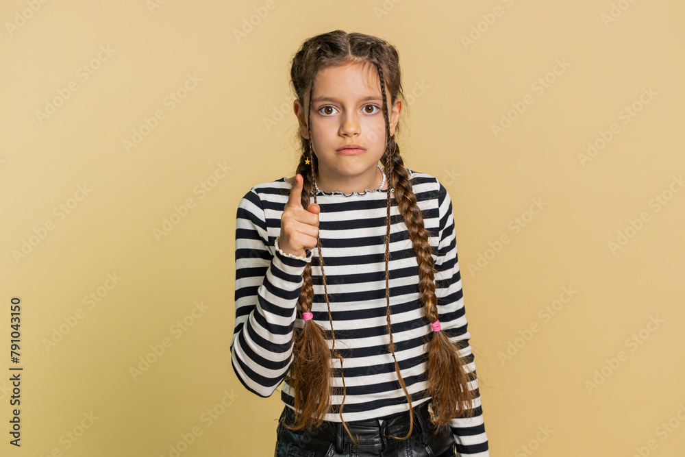Quarrel. Displeased young cute school girl gesturing hands with irritation and displeasure, blaming scolding for failure asking why this happened. Preteen child kid 10 years old on beige background Quarrel. Displeased young cute school girl gesturing hands with irritation and displeasure, blaming scolding for failure asking why this happened. Preteen child kid 10 years old on beige background