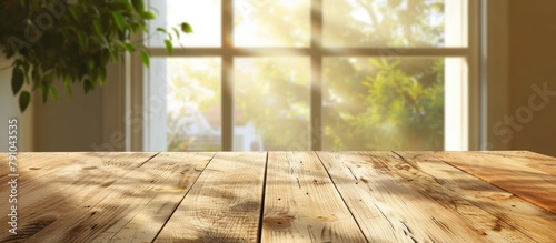 A light wooden textured table against a blurred summer window background. © Vusal