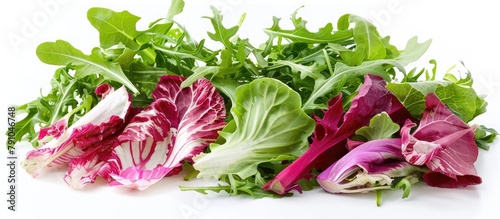 Salad combination featuring arugula, curly endive, radicchio, and lamb's lettuce. Presented against a white backdrop. photo