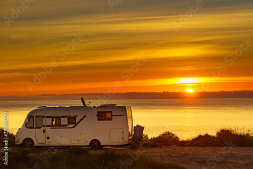 Caravan on sea at sunrise. © Voyagerix