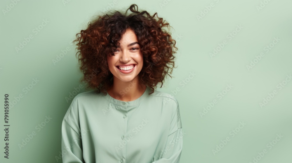 Radiant Young Woman with Curly Hair Smiling Against Pastel Background Radiant Young Woman with Curly Hair Smiling Against Pastel Background